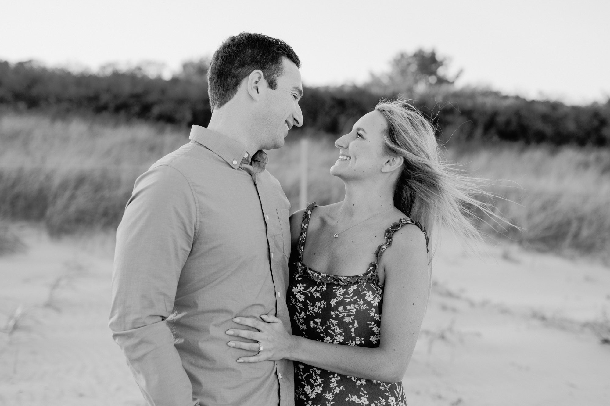 Black and white engagement photo of couple on the beach. Maine wedding & engagement photography