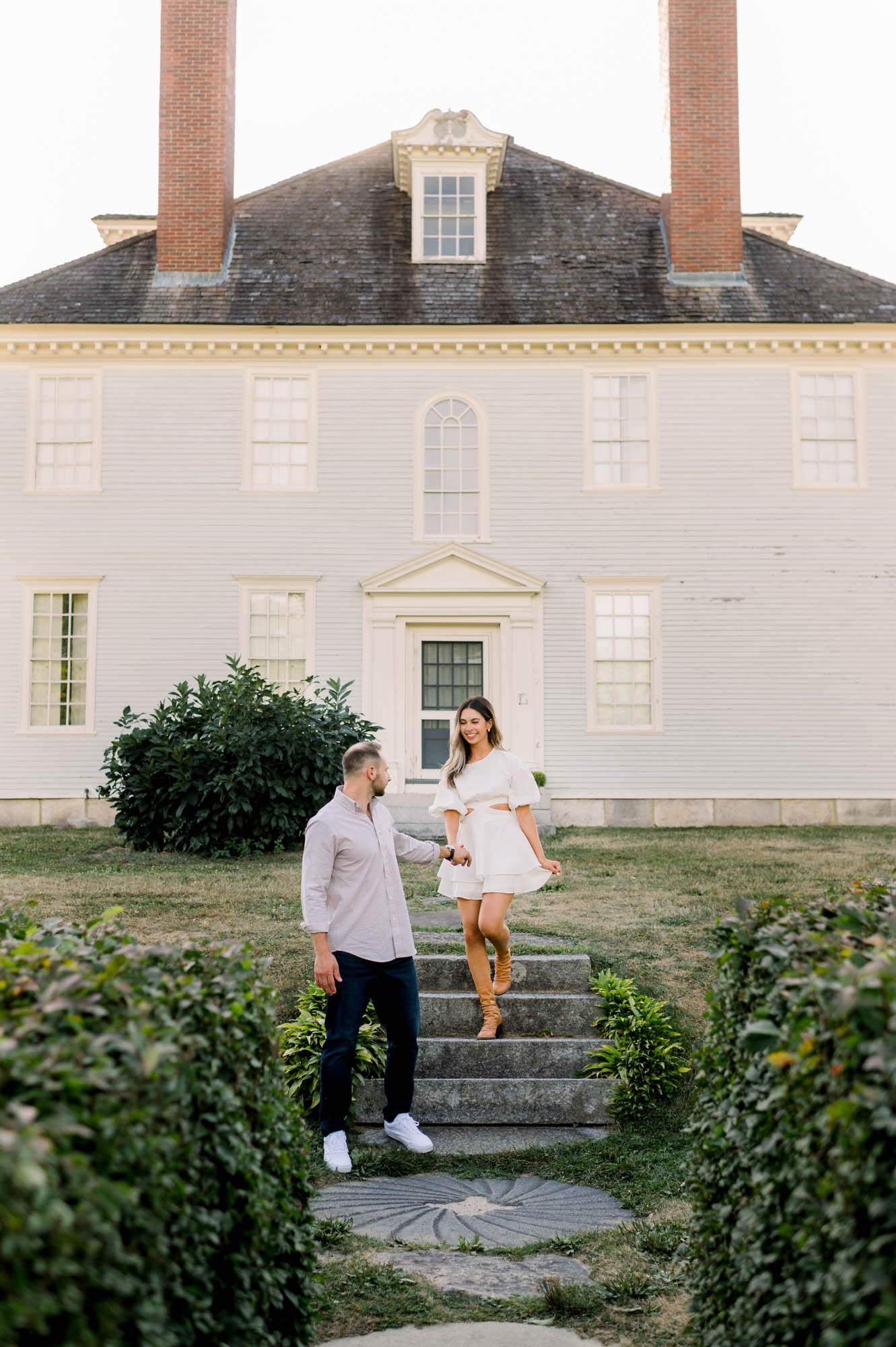 Mansion engagement photo of couple on steps in southern Maine