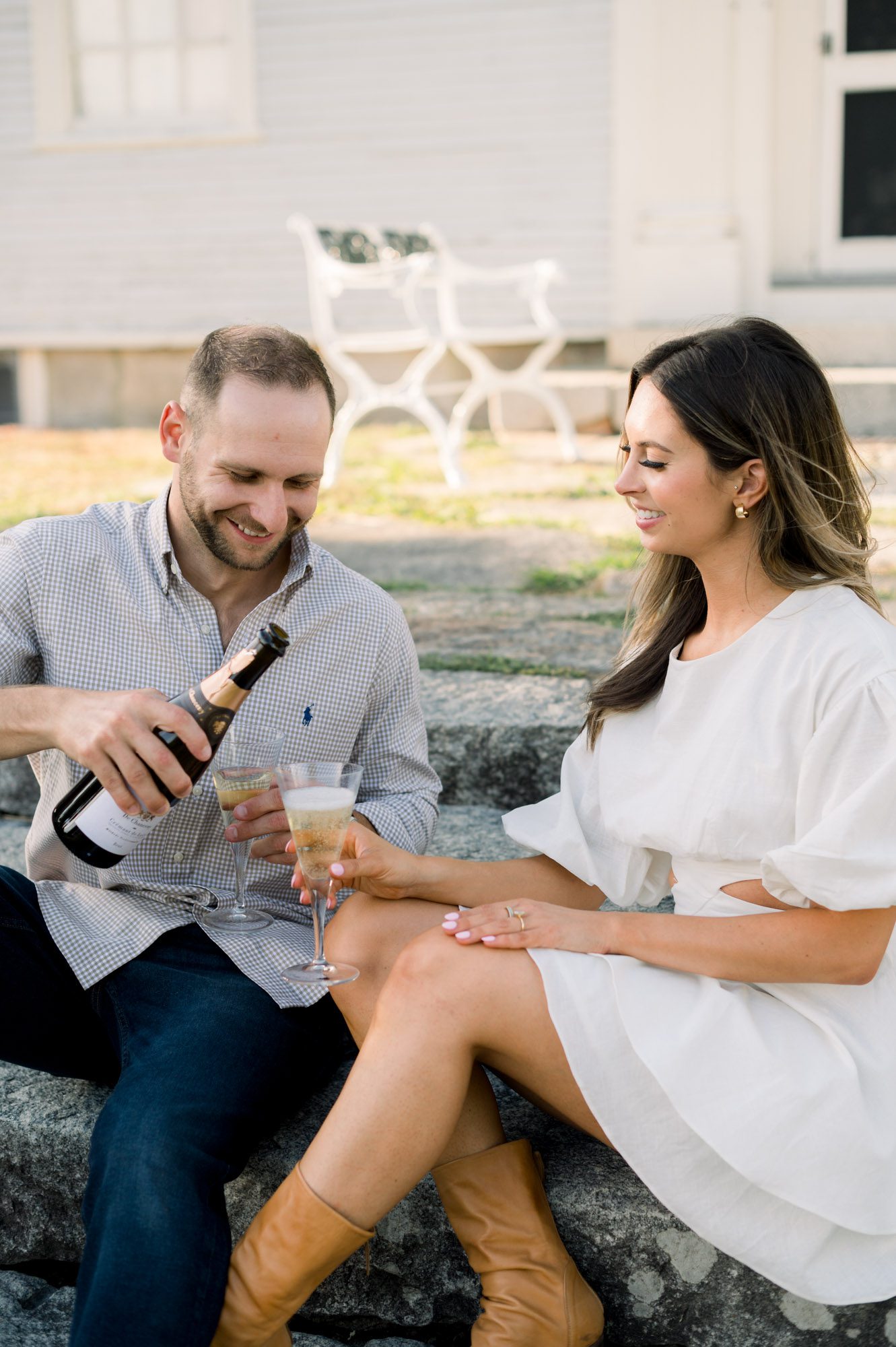 Couple having a champagne toast during their engagement photo session. Photographed by Maine wedding photographer Casey Durgin