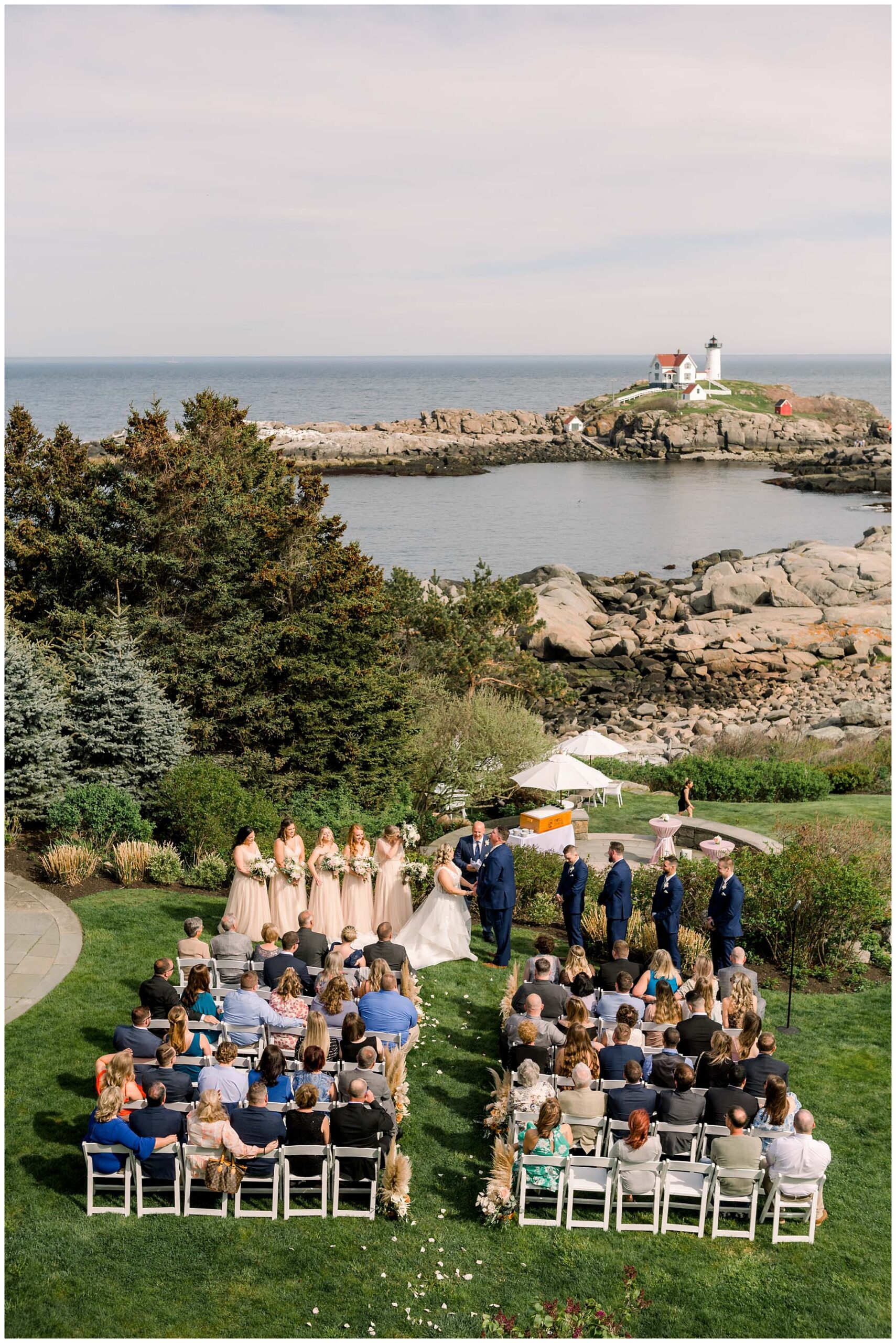 Birdseye view of viewpoint hotel wedding ceremony with Nubble Lighthouse in the distance.
