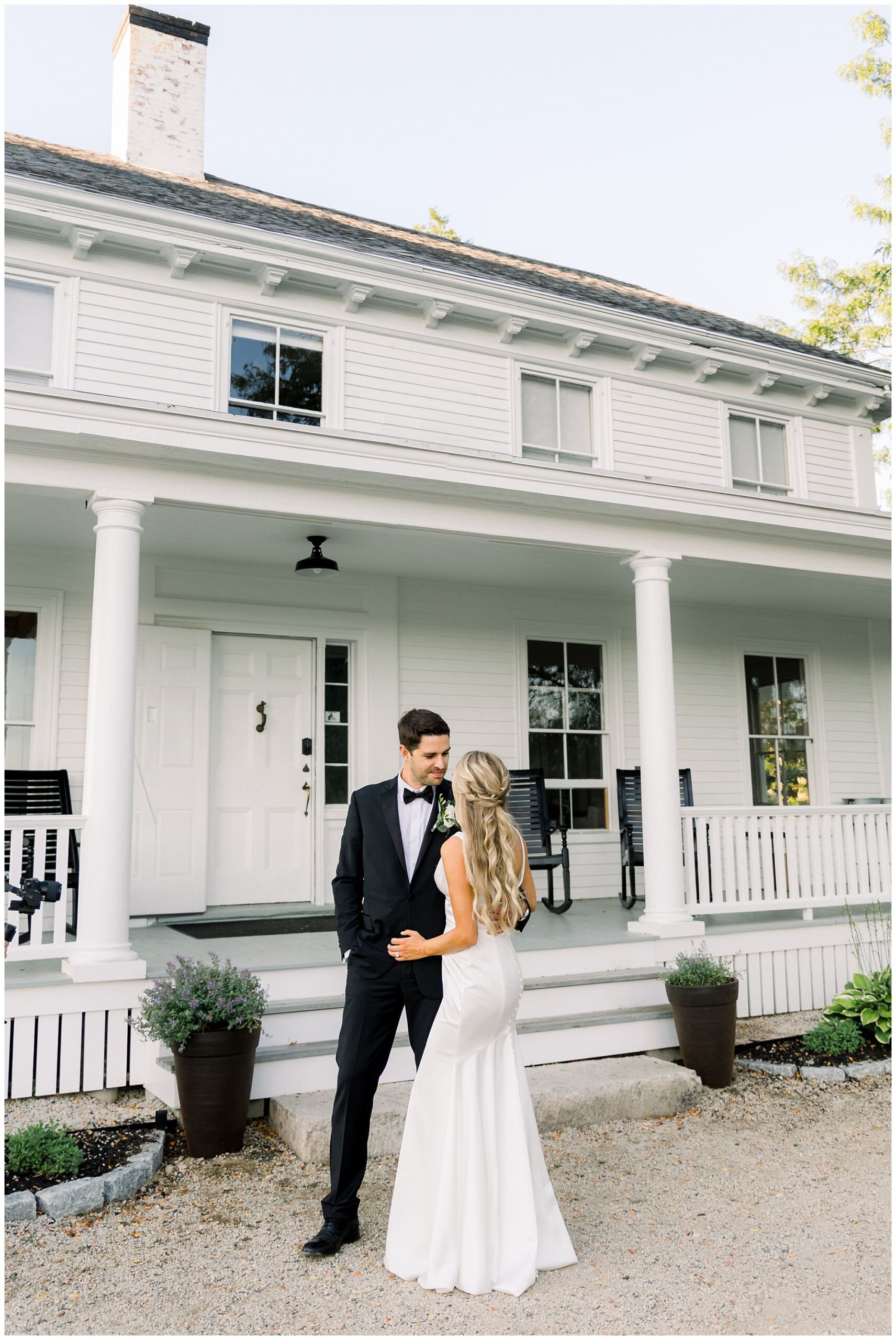 Portraits of bride & groom in front of the farmhouse at Scotland fields 