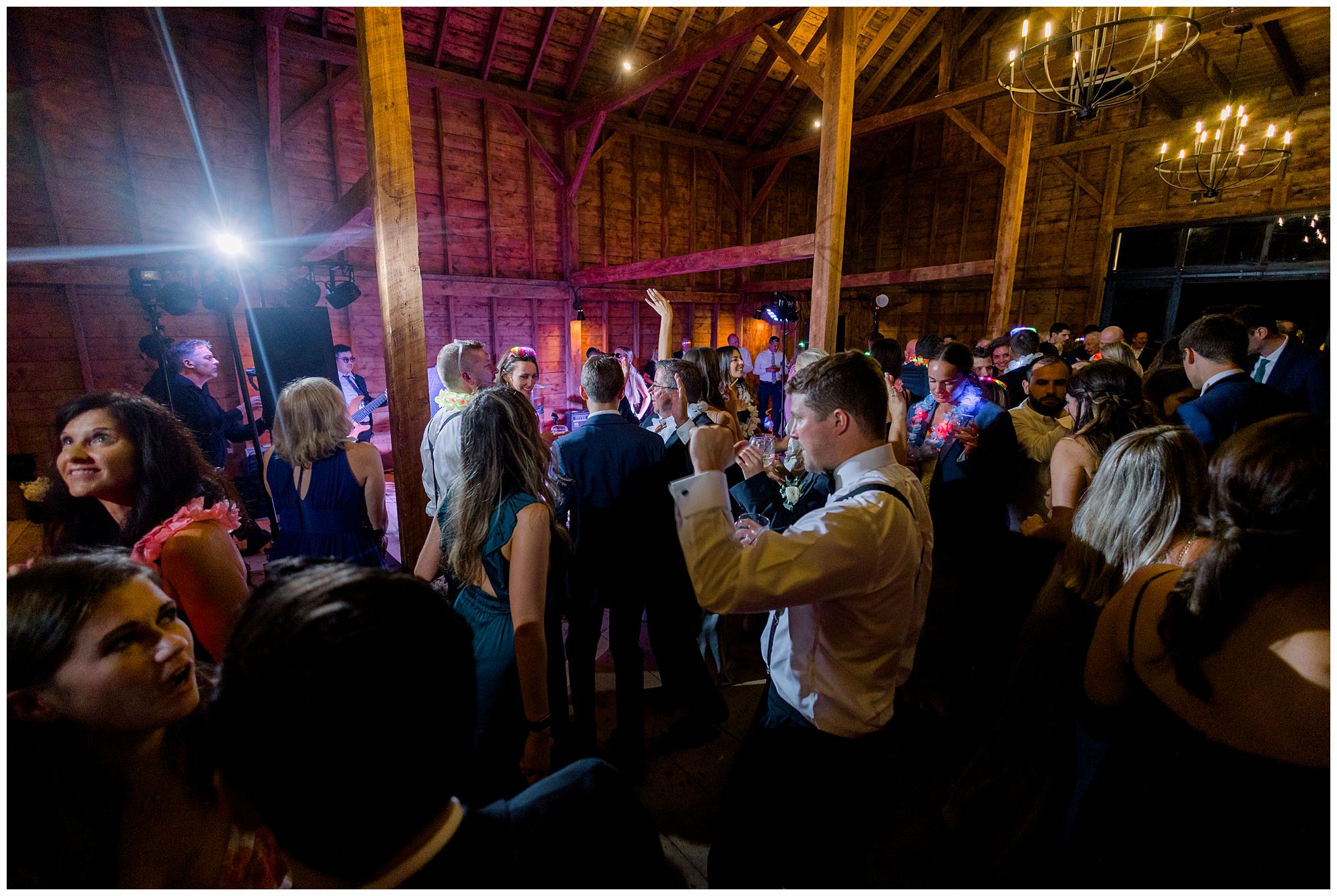 Wedding guests dance at Scotland Fields wedding reception inside barn