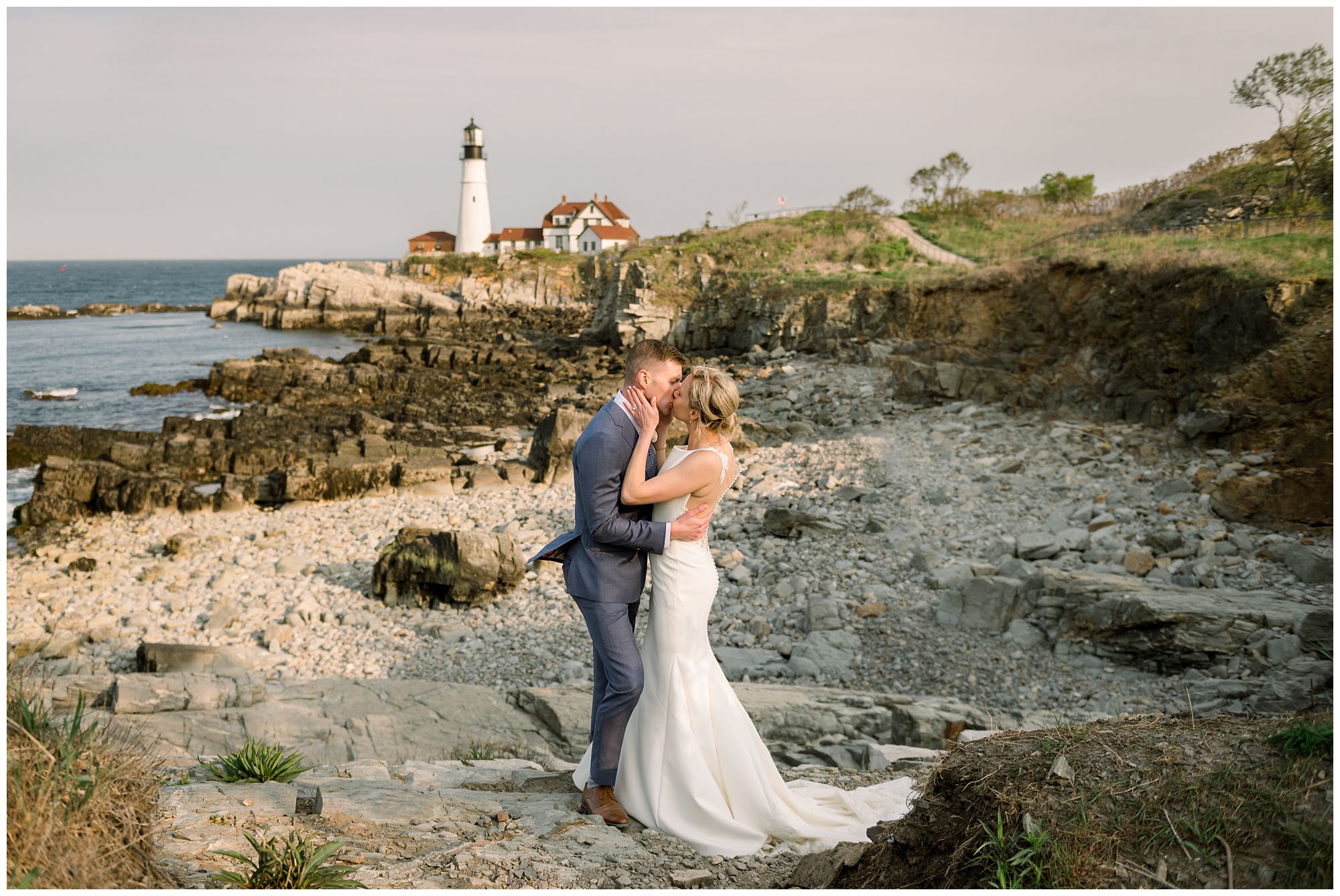 Bride & Groom Kiss with Portland Head Light in the distance