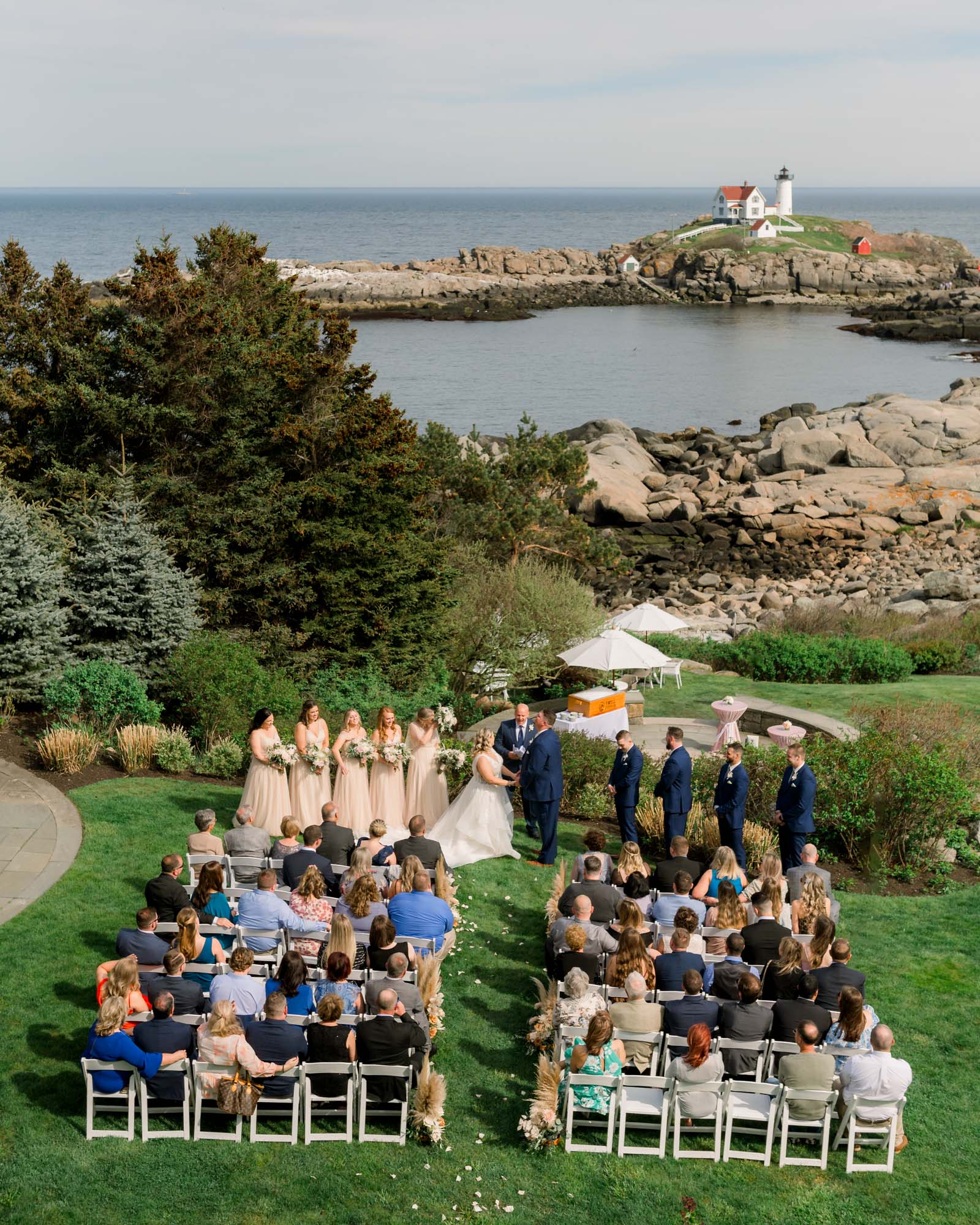 Bird's eye view of wedding ceremony at Viewpoint Hotel in York Maine with Nubble light in the distance.