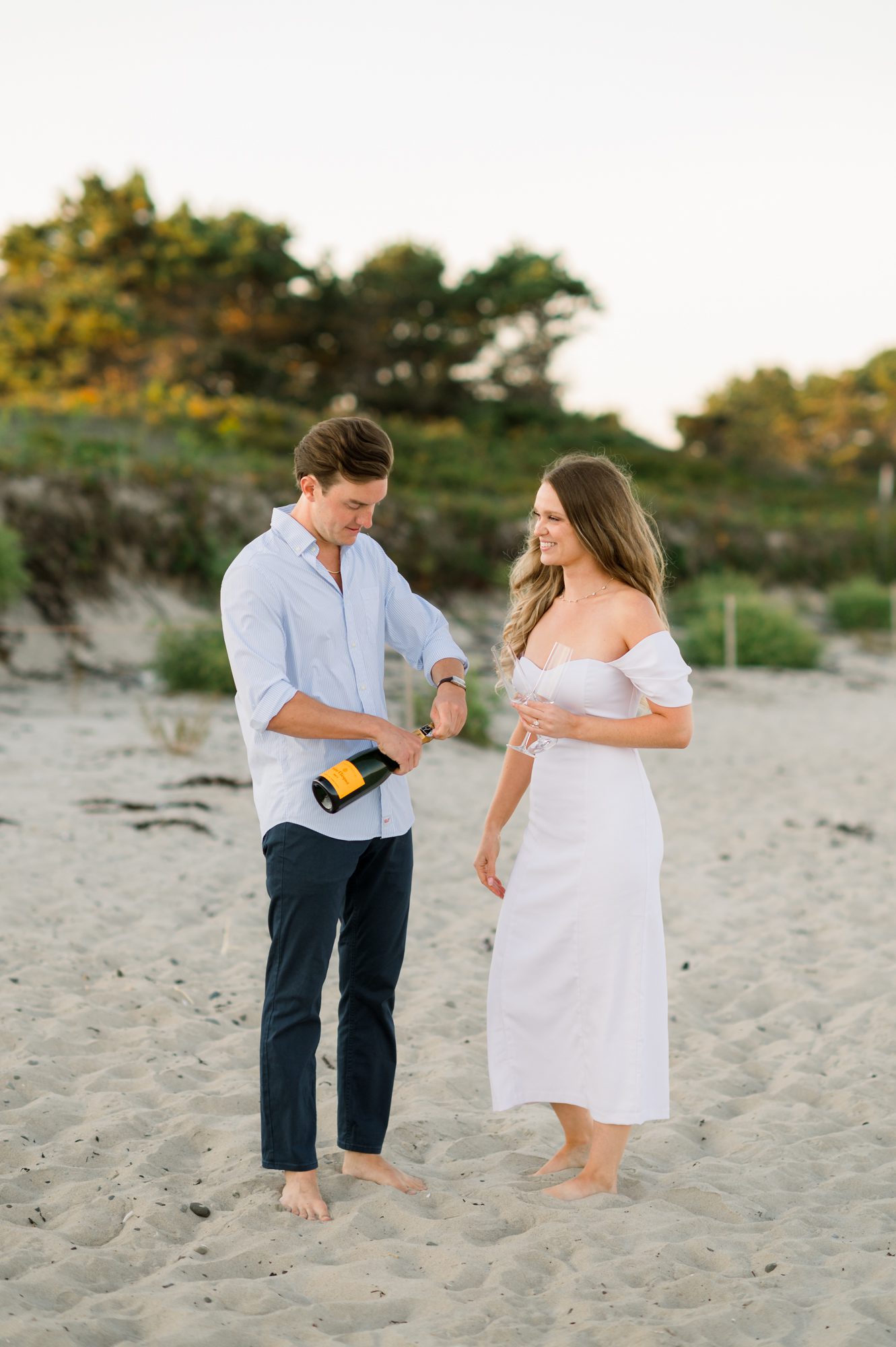 Champagne toast at Footbridge Beach engagement session