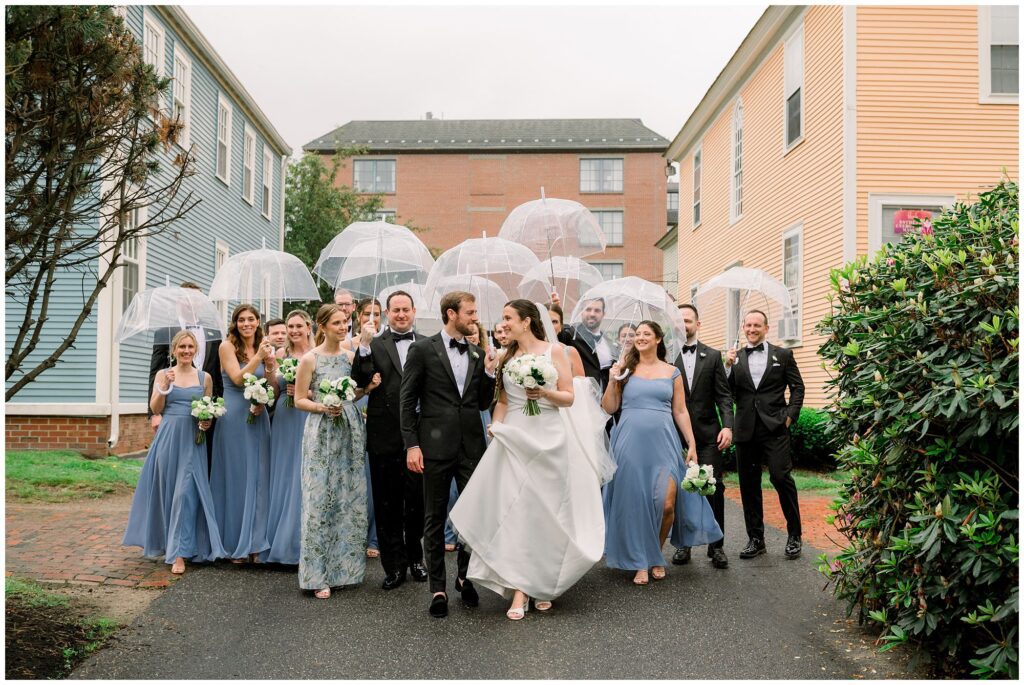 Wedding party walking under umbrellas in downtown Portsmouth, NH